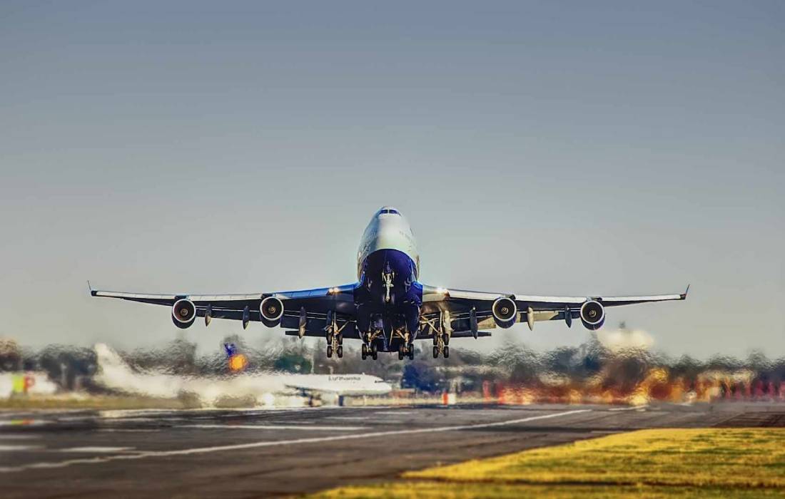 An image of a flight taking off, representing increasing air traffic at Trichy International Airport, with numerous flights arriving and departing